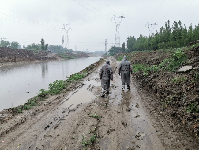 程林枫和职光跃暴雨中巡查白马门河河道过流情况
