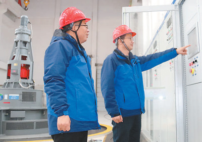 南水北调东线工程山东段济宁市邓楼泵站，工作人员在主厂房电机层检查设备运行情况。肖家鑫 黄雪梅摄影报道